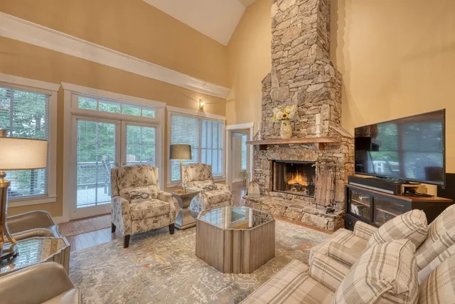 a view of a livingroom with wooden floor and a flat screen tv