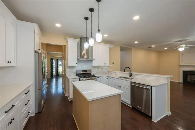 a kitchen with a sink stove and wooden floor