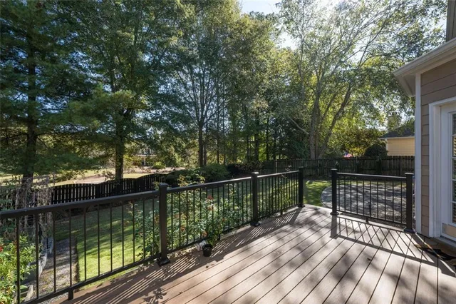 a view of balcony with wooden floor and fence