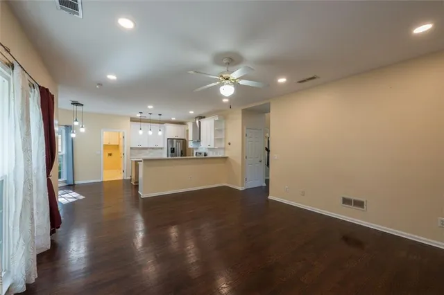 a view of a kitchen with a sink and a refrigerator