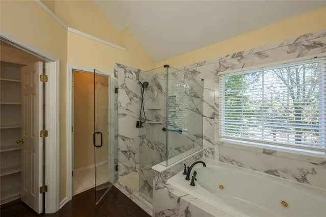 a bathroom with a bathtub and a shower