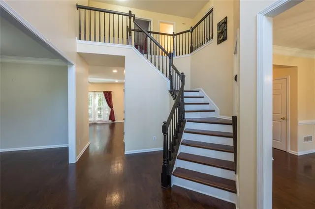 a view of front door with wooden floor and stairs