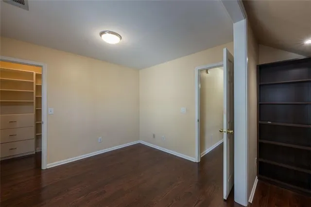 an empty room with wooden floor