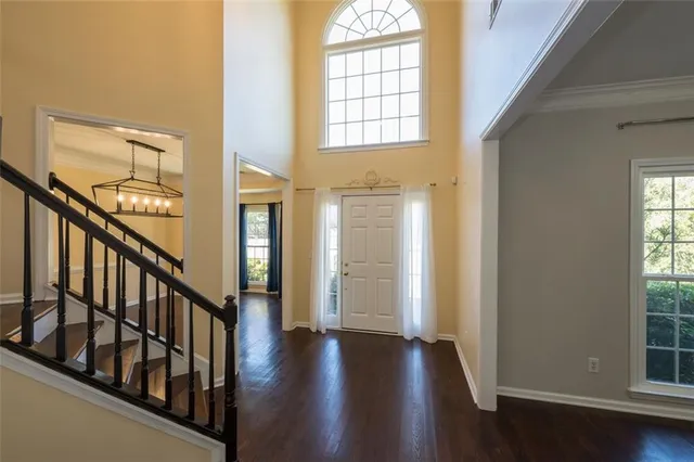 a view of an entryway with wooden floor and windows
