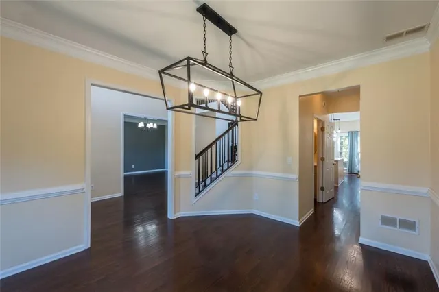 a view of a hallway with wooden floor and stairs