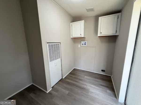 a view of cabinets and wooden floor
