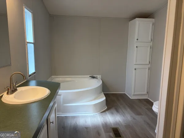 a bathroom with a tub and a sink