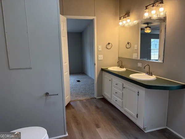 a spacious bathroom with a double vanity sink mirror and toilet