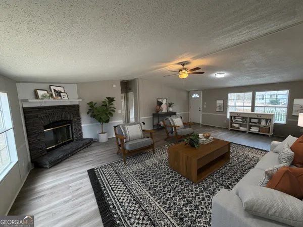 a living room with furniture and a fireplace