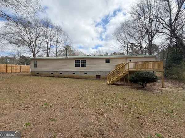 a view of a house with a yard covered with snow in front of house