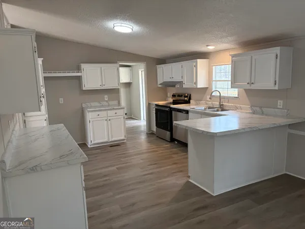 a kitchen with a sink stove and cabinets