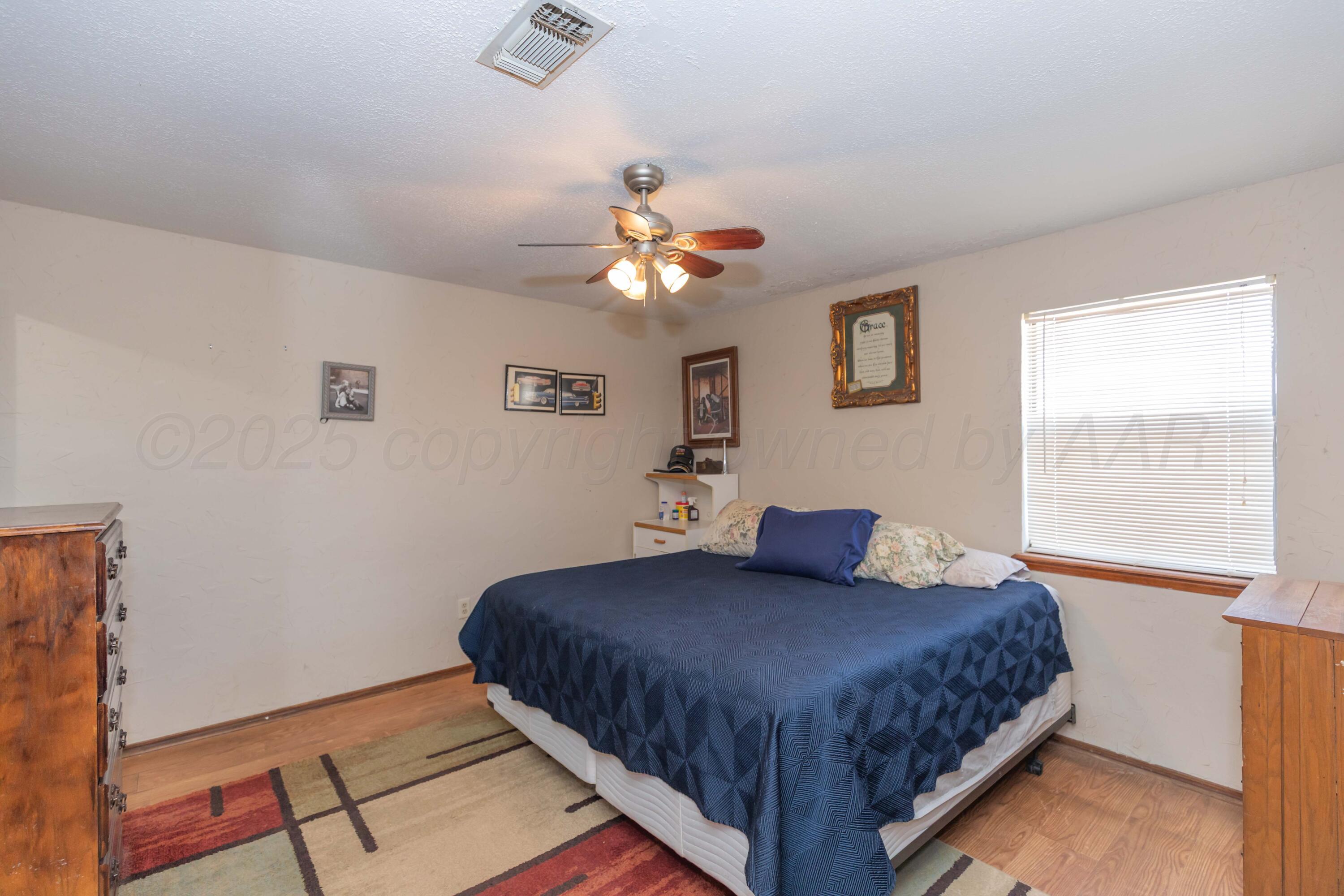 609 Groom Avenue Panhandle, TX 79068 - Photo 12 of 28 a bedroom with a large bed and a window