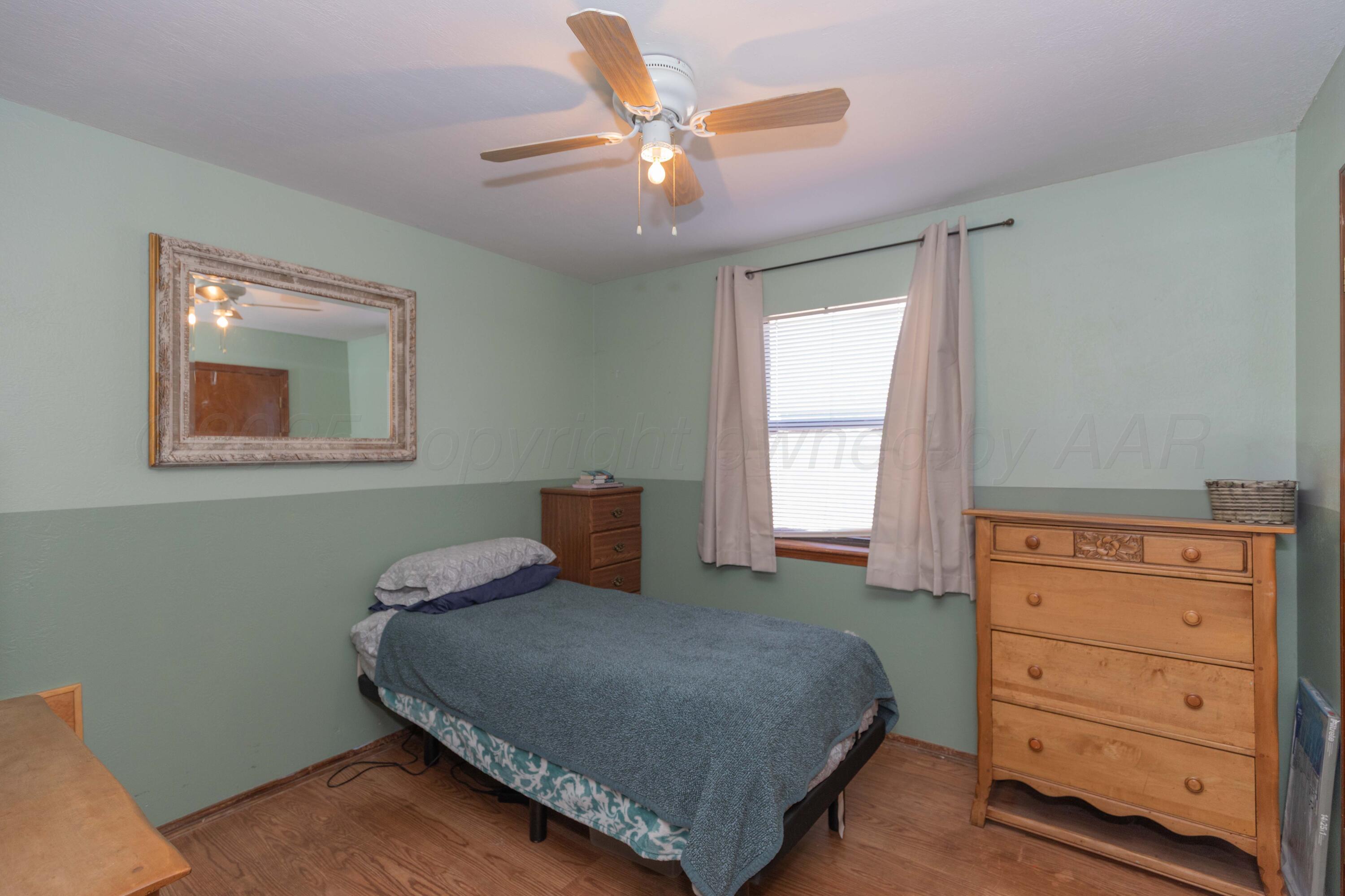 609 Groom Avenue Panhandle, TX 79068 - Photo 18 of 28 a bedroom with a bed and window