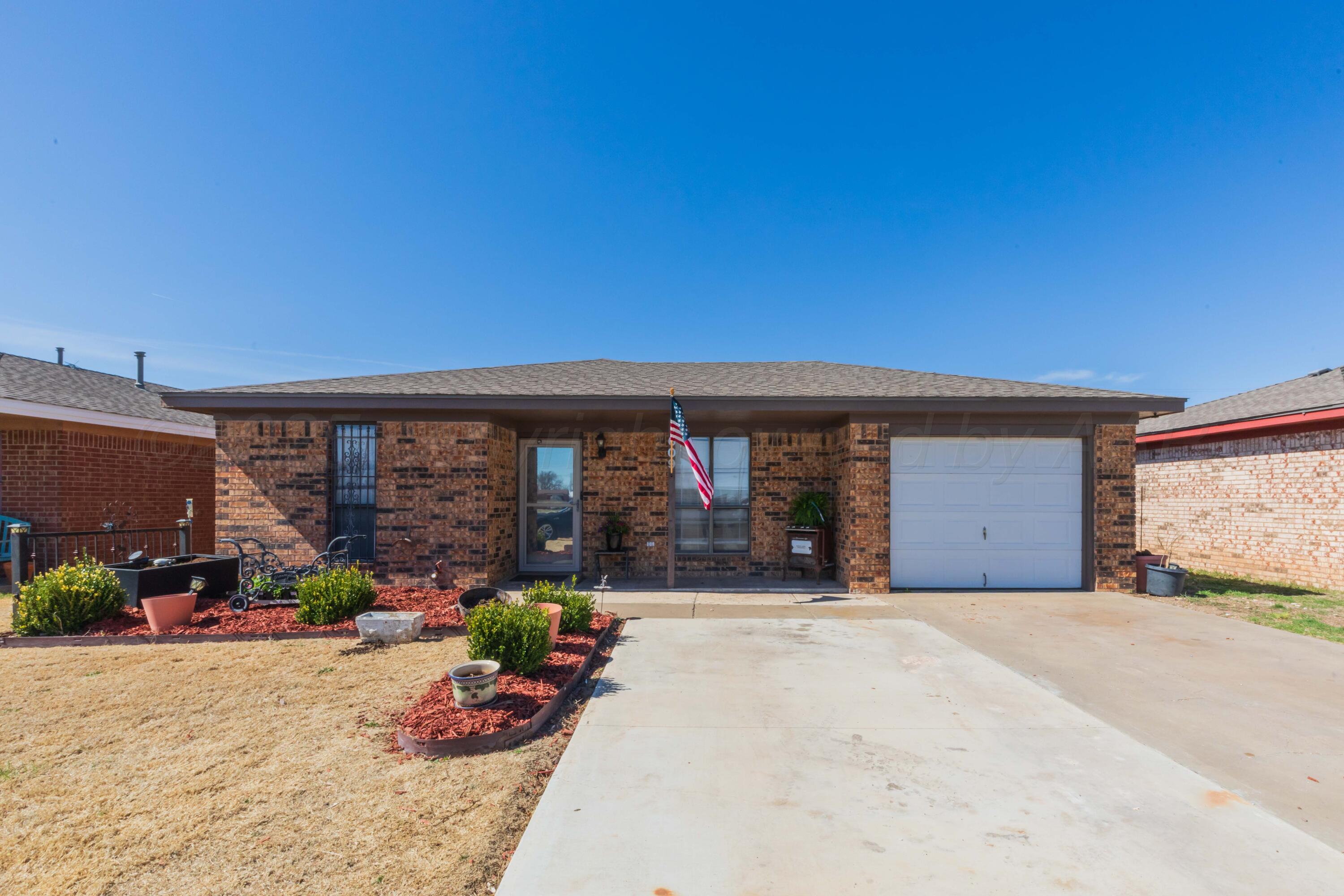 609 Groom Avenue Panhandle, TX 79068 - Photo 2 of 28 a front view of a house with a patio