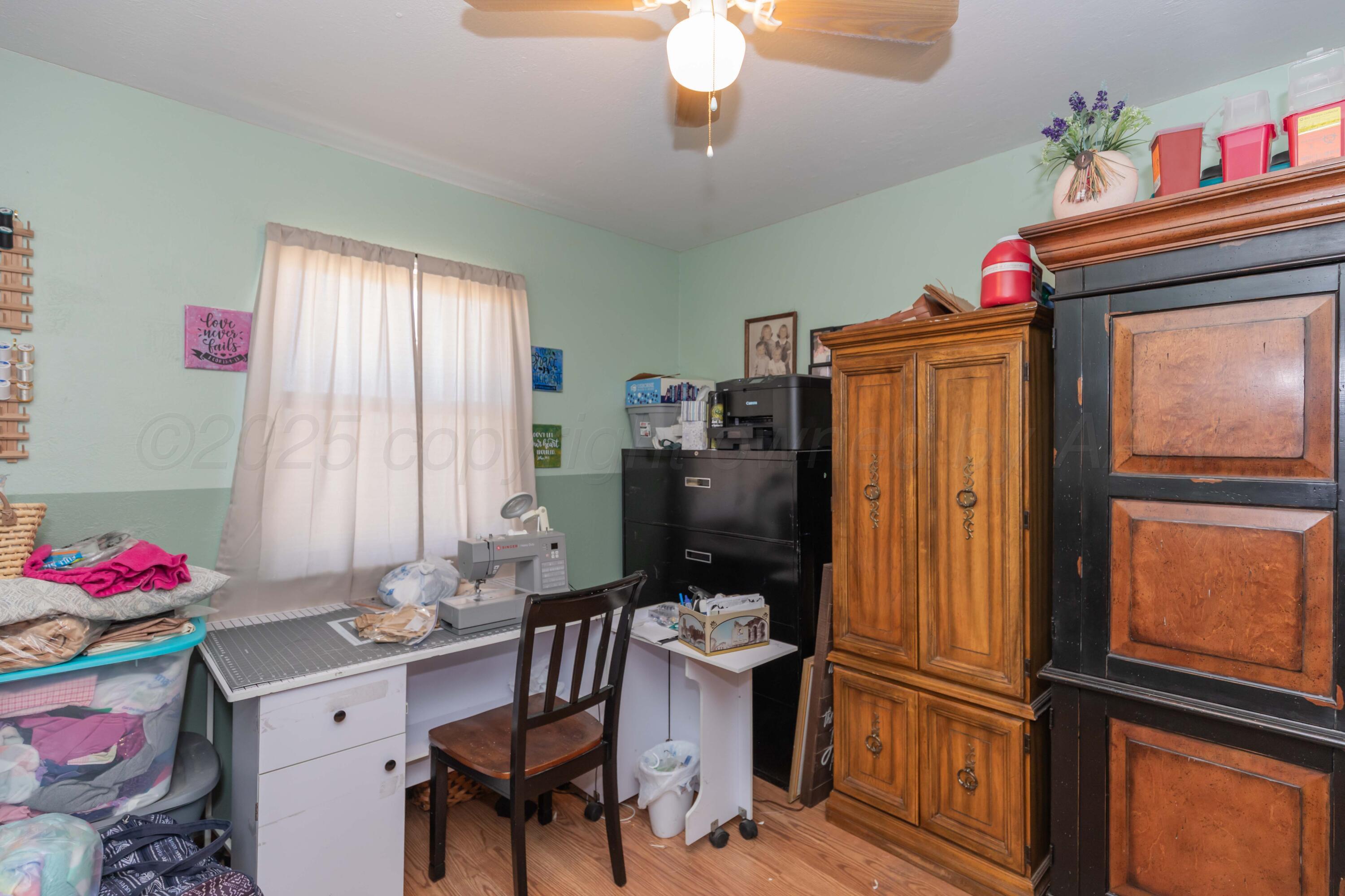 609 Groom Avenue Panhandle, TX 79068 - Photo 23 of 28 a view of a workspace with furniture and a window