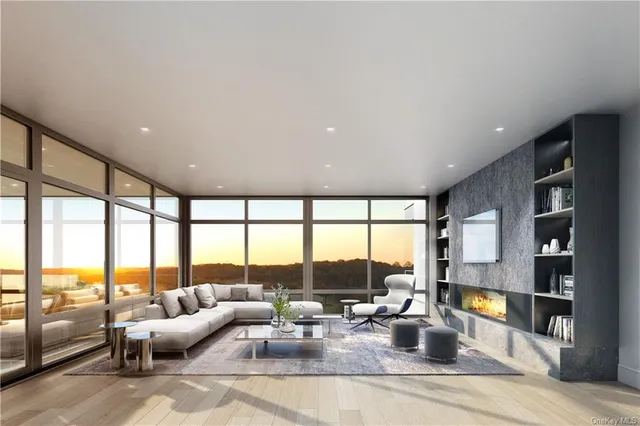 a living room with furniture and floor to ceiling windows