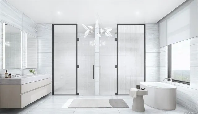 a spacious bathroom with a double vanity sink a mirror and a shower