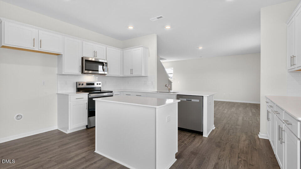 181 Fair Child Road Spring Lake, NC 28390 - Photo 11 of 43 a kitchen with cabinets stainless steel appliances and wooden floor