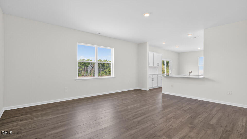 181 Fair Child Road Spring Lake, NC 28390 - Photo 14 of 43 a view of an empty room with wooden floor and a window