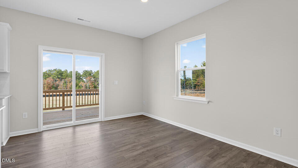 181 Fair Child Road Spring Lake, NC 28390 - Photo 15 of 43 a view of an empty room with wooden floor and a window