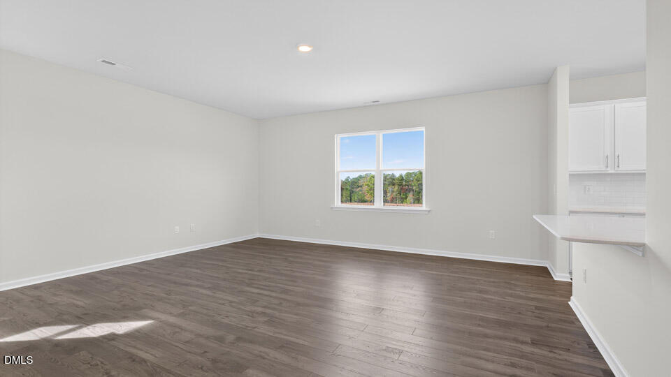181 Fair Child Road Spring Lake, NC 28390 - Photo 16 of 43 an empty room with wooden floor and windows