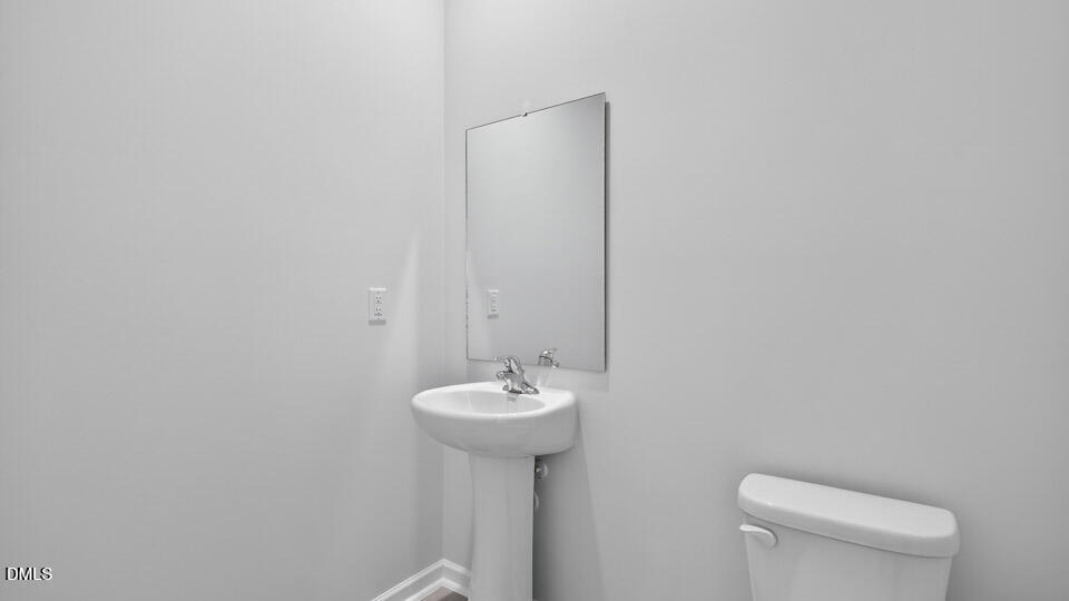 181 Fair Child Road Spring Lake, NC 28390 - Photo 31 of 43 a bathroom with a sink a toilet and a mirror