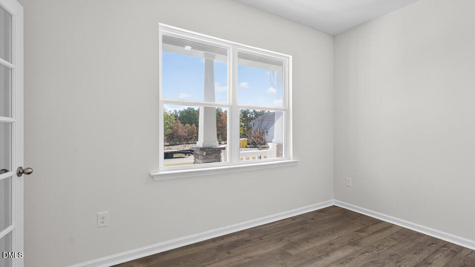 181 Fair Child Road Spring Lake, NC 28390 - Photo 6 of 43 a view of an empty room with wooden floor and a window