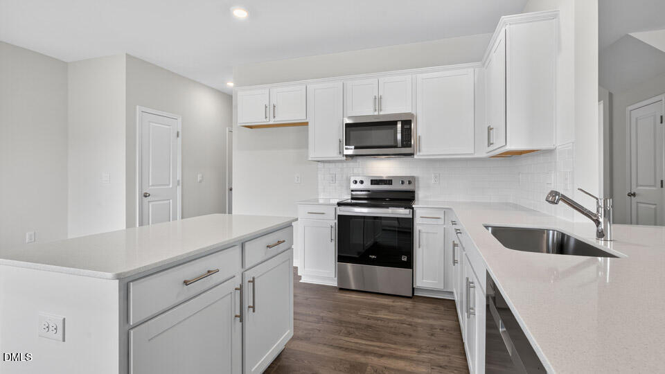 181 Fair Child Road Spring Lake, NC 28390 - Photo 9 of 43 a kitchen with white cabinets and stainless steel appliances
