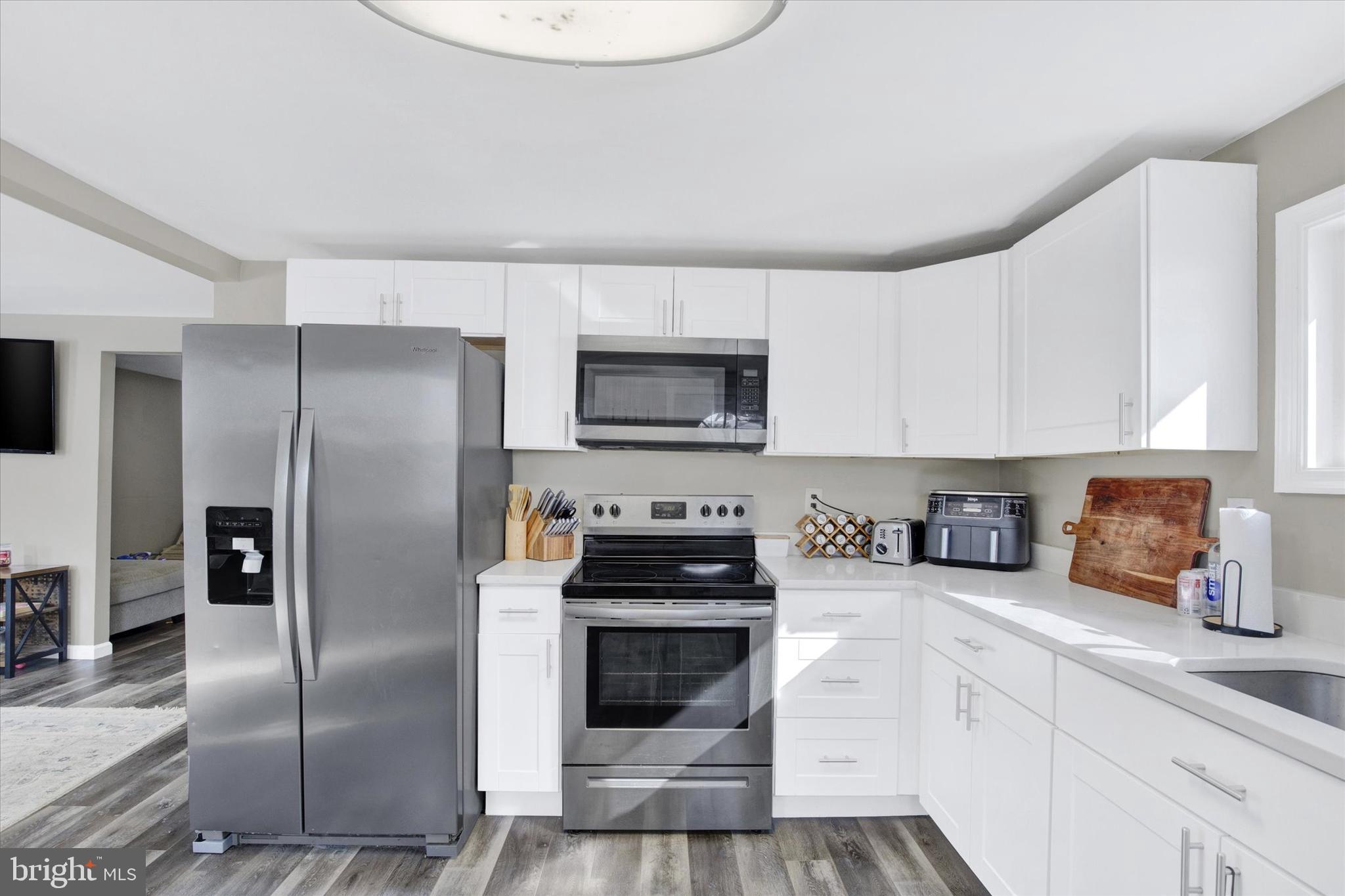 228 Porters Bridge Road Colora, MD 21917 - Photo 7 of 29 a kitchen with granite countertop a refrigerator stove and microwave