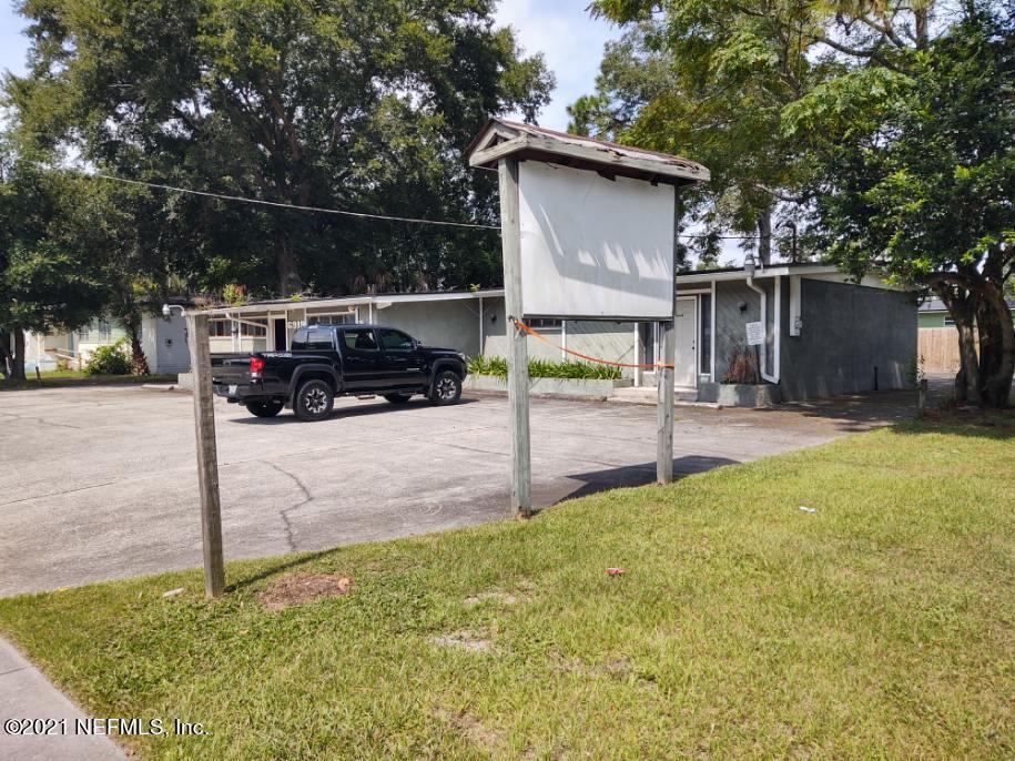 6919 Merrill Road Jacksonville, FL 32277 - Photo 3 of 19 a side view of a house with backyard