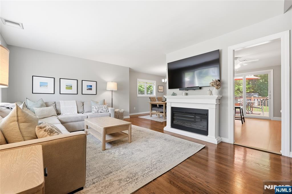 77 White Pond Road Waldwick, NJ 07463 - Photo 2 of 33 a living room with furniture a flat screen tv and a fireplace