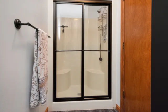 a bedroom with a bed and a large mirror