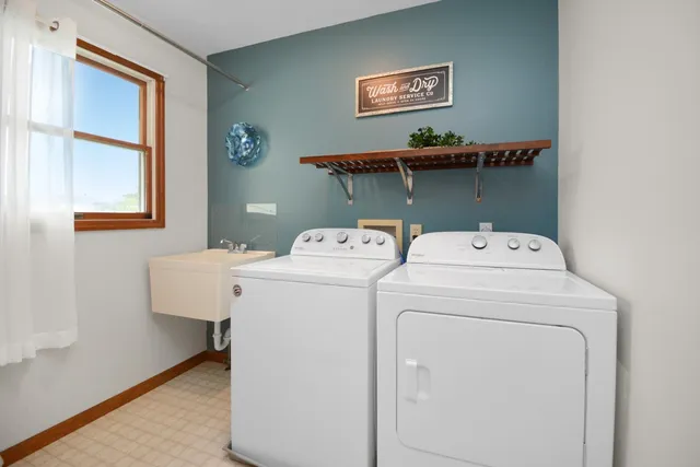 a kitchen with stainless steel appliances granite countertop wooden cabinets a sink and dishwasher with wooden floor