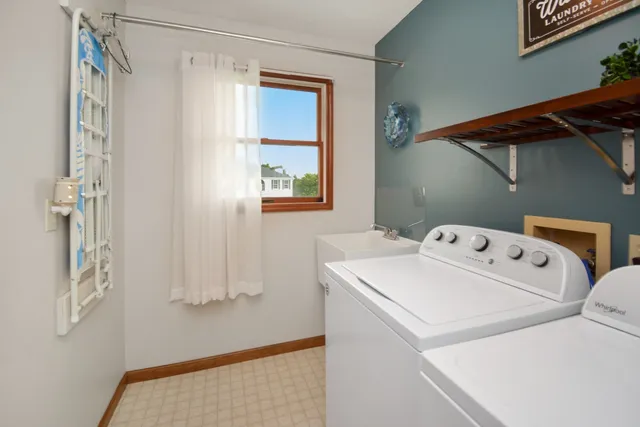 a kitchen with stainless steel appliances a sink a counter top space cabinets and a window