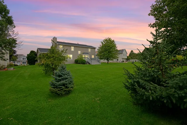 a view of a door and chair and potted plants