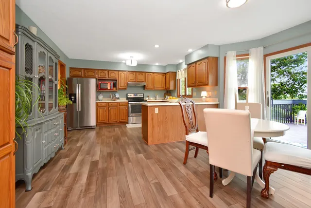 a kitchen with granite countertop a refrigerator stove and cabinets