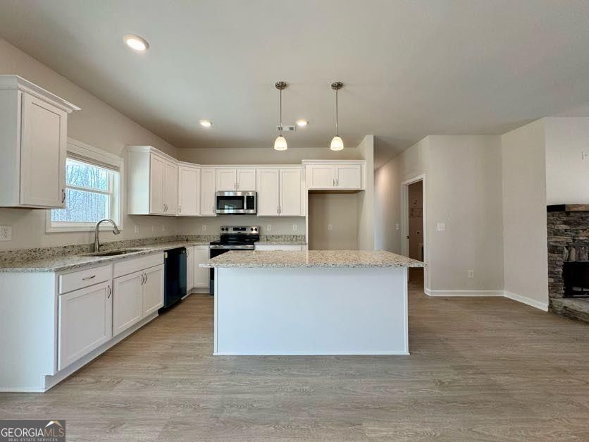 239 Cool Springs Road Clarkesville, GA 30523 - Photo 23 of 37 a large kitchen with stainless steel appliances a large counter top a stove a sink dishwasher and a refrigerator