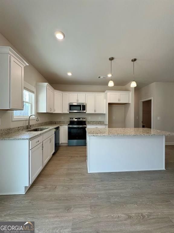 239 Cool Springs Road Clarkesville, GA 30523 - Photo 24 of 37 a large kitchen with stainless steel appliances kitchen island a large counter top and a stove