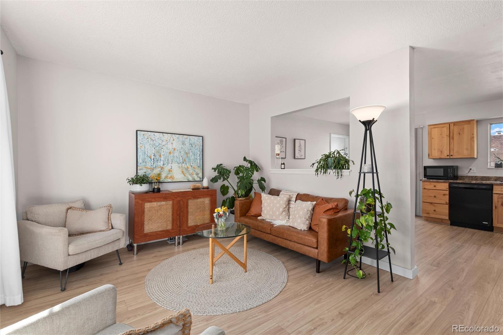 2463 South Memphis Way Aurora, CO 80013 - Photo 4 of 32 a living room with furniture and a wooden floor