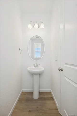 a room with wooden floor and staircase