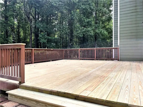 a view of wooden deck and a backyard