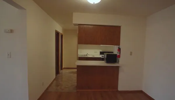 a kitchen with a refrigerator and a stove