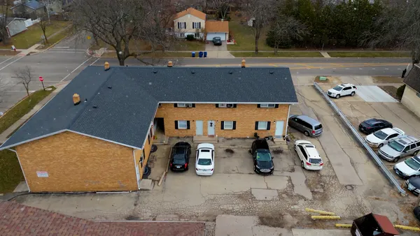 an aerial view of a house with a yard
