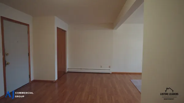 an empty room with wooden floor