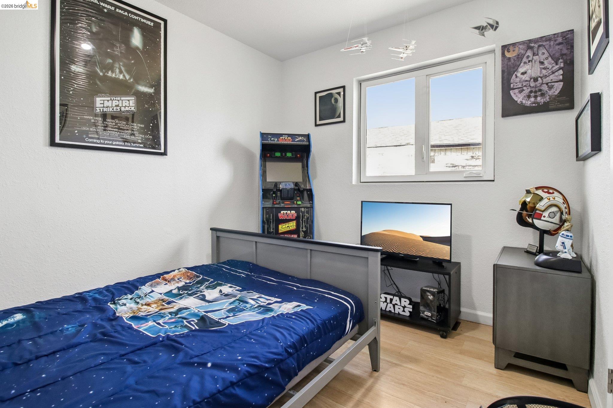 874 Pine Street Oakland, CA 94607 - Photo 21 of 39 Bedroom featuring light wood-finish flooring, white painted walls, and a white framed window