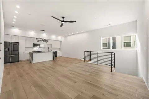 a view of kitchen with refrigerator microwave and stove
