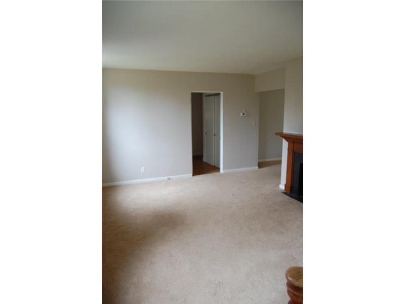 Living Room. Large bright space features a fireplace.