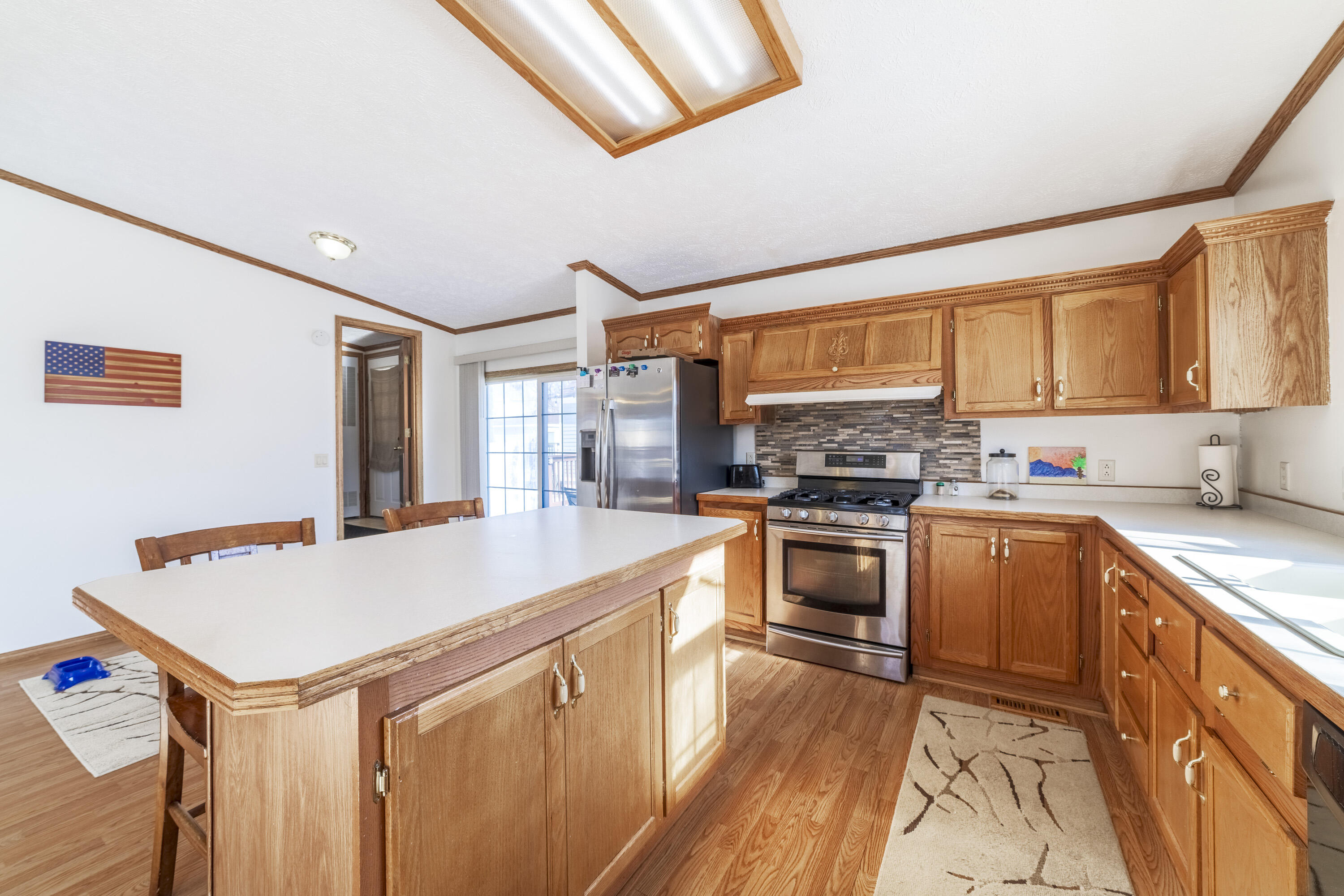 409 South Street Hebron, IN 46341 - Photo 12 of 36 a kitchen with a stove a sink and a refrigerator