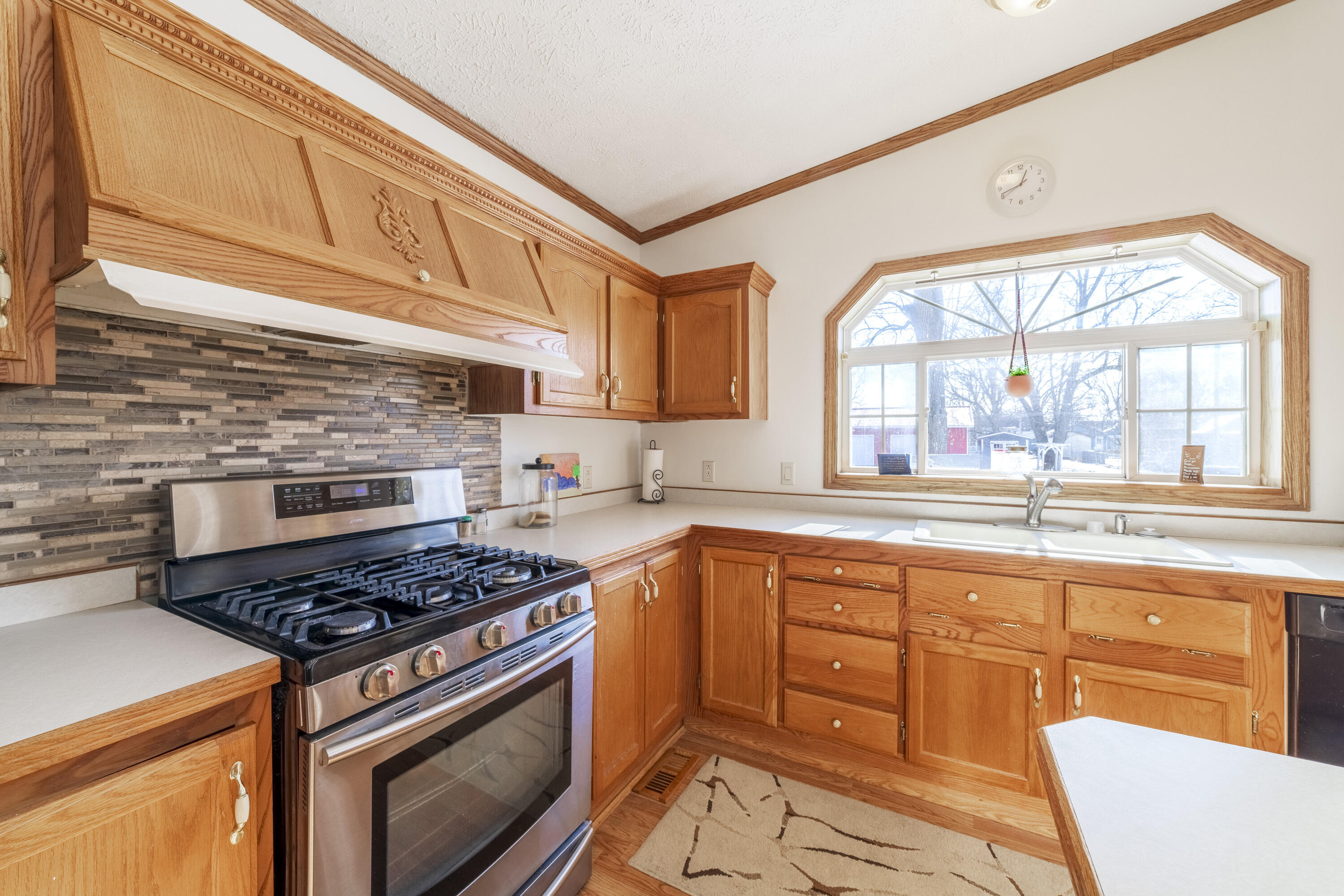 409 South Street Hebron, IN 46341 - Photo 14 of 36 a kitchen with stainless steel appliances granite countertop a stove and a sink