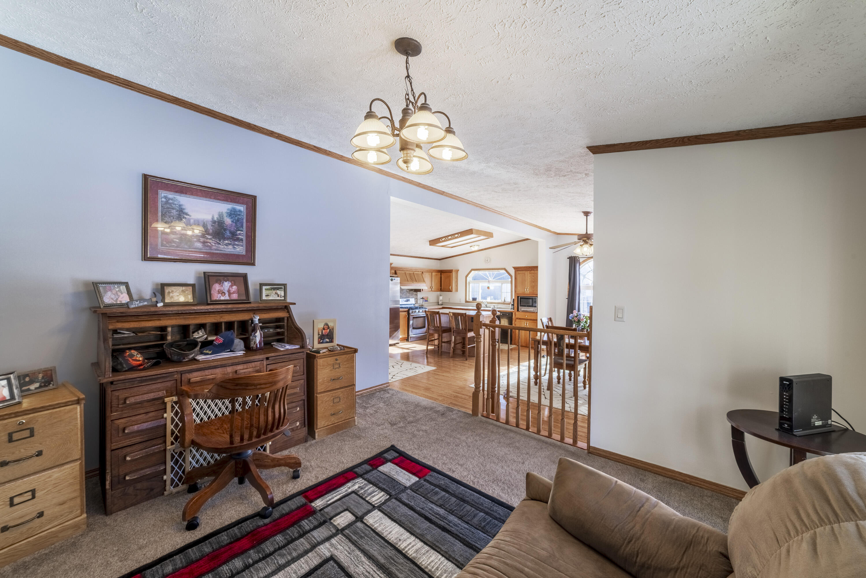 409 South Street Hebron, IN 46341 - Photo 19 of 36 a living room with furniture and a chandelier